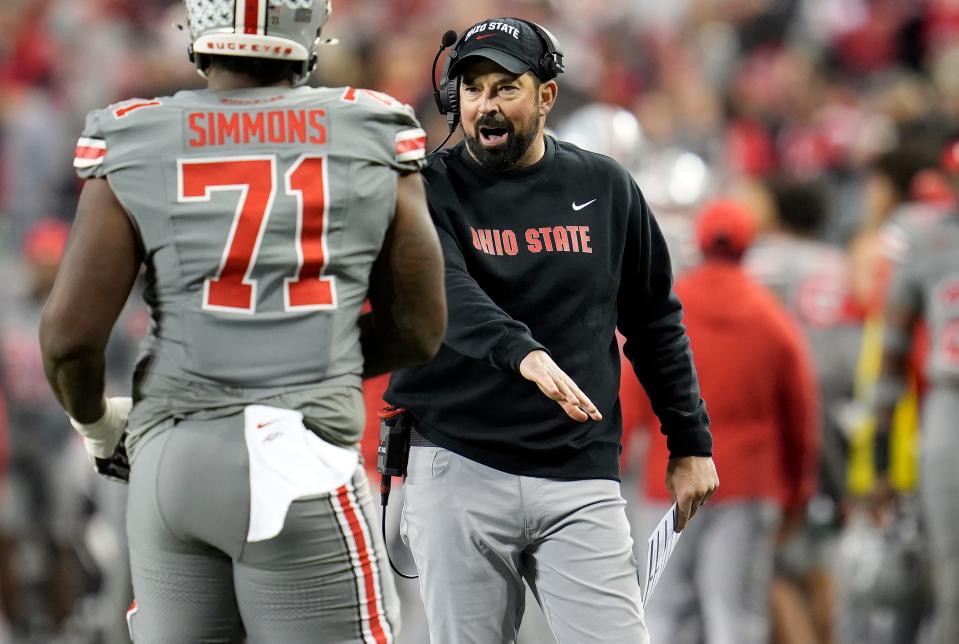 Ohio State coach Ryan Day cheers tackle Josh Simmons as he returns to the sideline during a game against Michigan State.