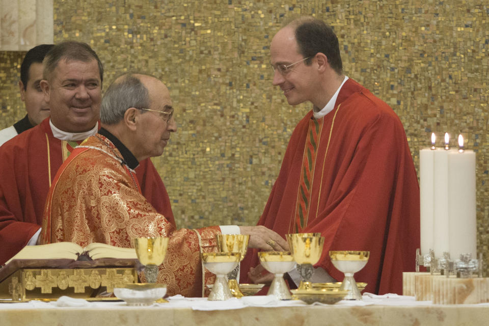 Cardinal Velasio De Paolis, left, exchanges a sign of peace with Legion of christ current leader Rev. Sylvester Heerman during a mass he celebrated at the Legion's main headquarters, the Ateneo Pontificio Regina Apostolorum, in Rome, Wednesday, Jan. 8, 2014. The mass marks the opening of the Legion of Christ’s General Chapter, the month-long meeting where they’re going to approve new constitutions and elect a new leadership, thus ending a Vatican’s three-year reform experiment. (AP Photo/Andrew Medichini)