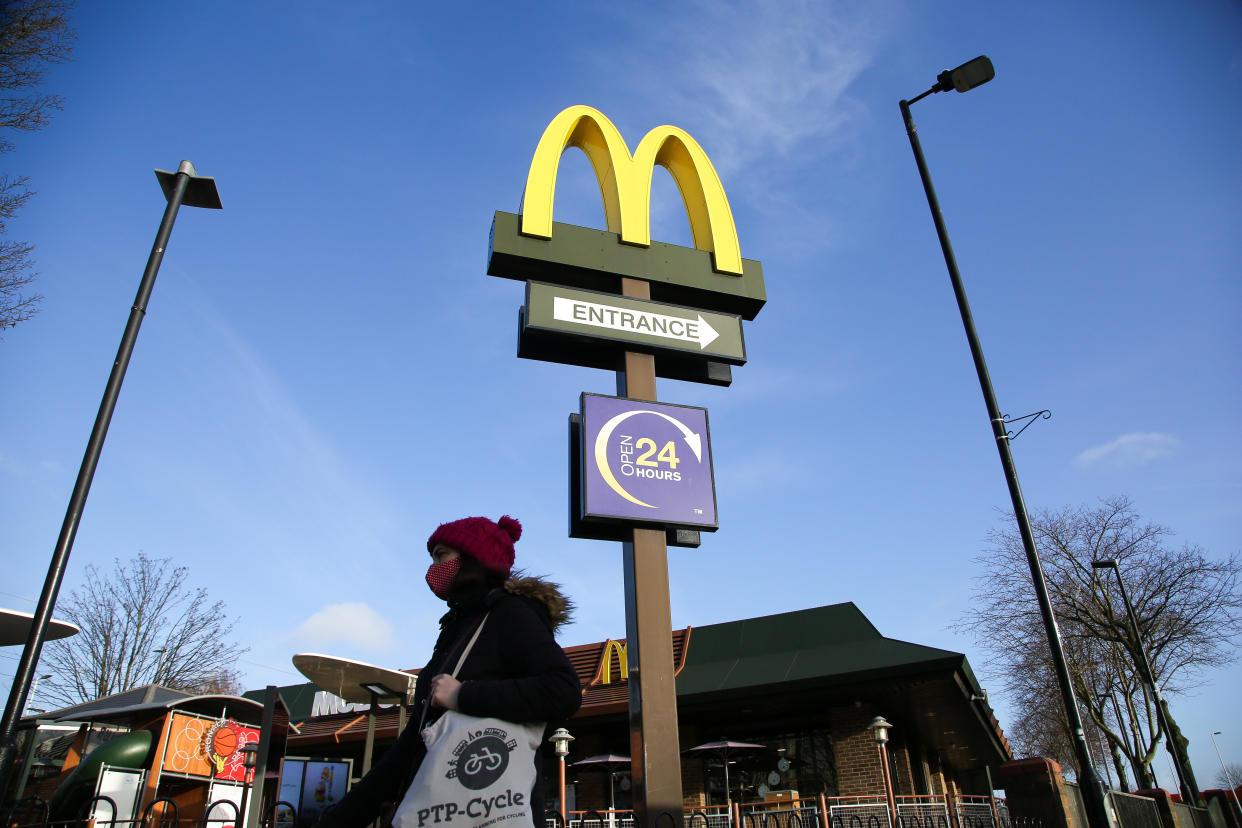 A woman wearing a face mask walks past a branch of McDonald's in London. (Photo by Dinendra Haria / SOPA Images/Sipa USA)