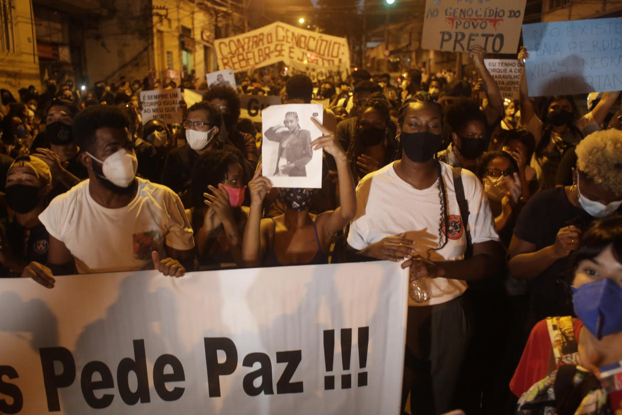 Family and activists protest the day after the killing of Kathlen Romeu, a young pregnant woman killed by a stray bullet, in Rio de Janeiro, Brazil, Wednesday, June 9, 2021. Stray bullets have struck at least six pregnant women in Rio since 2017, but Romeu was the first to die, according to Crossfire, a non-governmental data project that tracks armed violence. (AP Photo/Bruna Prado)