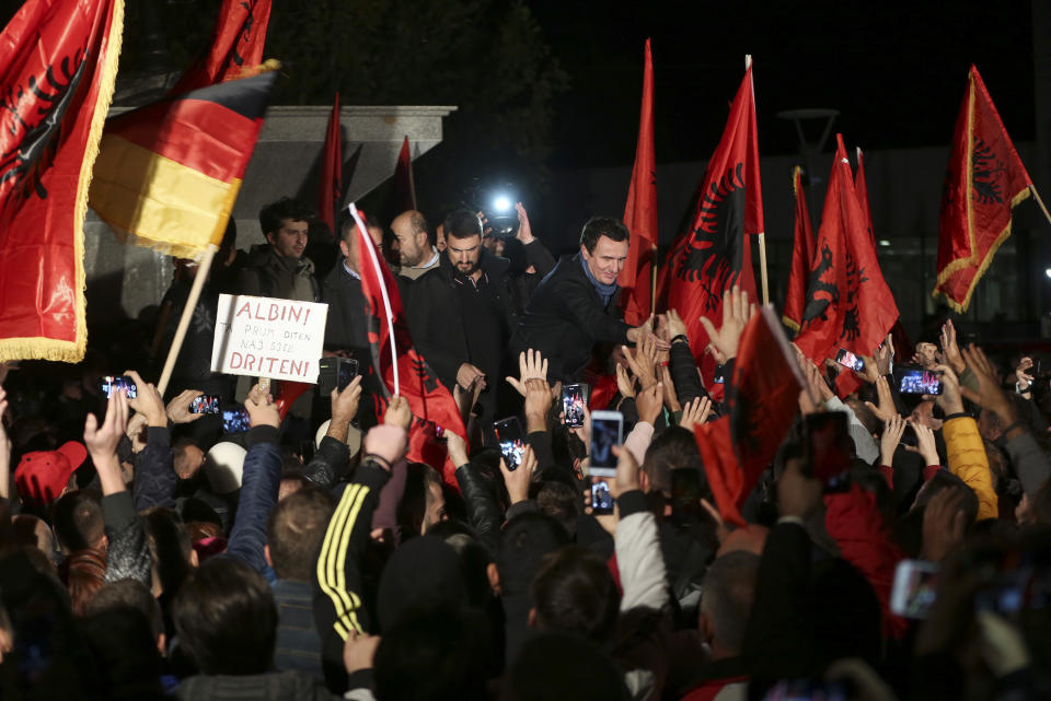 Albin Kurti, center, leader of Self-Determination Movement (Vetevendosje), greets a celebrating crowd gathered after winning the parliamentary elections in Kosovo capital Pristina early Monday, Oct. 7, 2019. Two Kosovo opposition parties emerged as the top-vote getters in Sunday's snap election of a new parliament held amid calls for leaders to resume dialogue with Serbia over normalizing ties. Self-Determination supporters took to the streets to celebrate. (AP Photo/Visar Kryeziu)