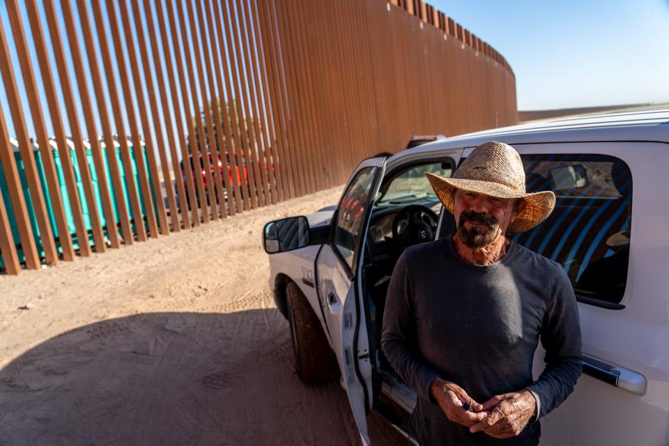 Luis Ames, a local agricultural worker who drops off food and water for migrants and asylum seekers waiting to be picked up by Border Patrol agents, stands along the U.S.-Mexico border in San Luis, Ariz., on May 12, 2023.