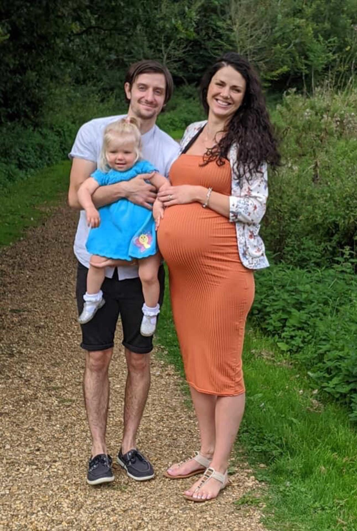 Breast cancer survivor Kate Pistilli with her husband, Giuseppe, and their eldest daughter, while pregnant with their second child. (Caters)