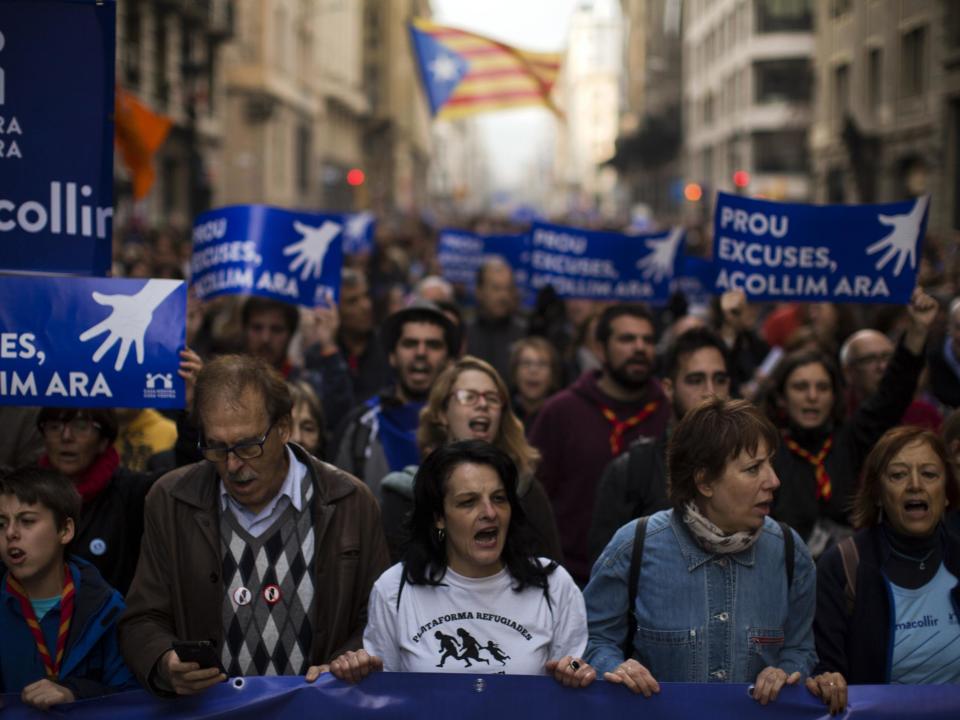 Demonstrators march as they take part in a protest along the street in downtown Barcelona, Spain (Associated Press)