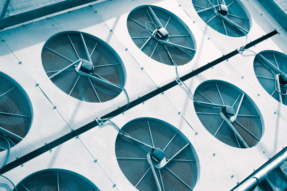 Array of industrial fans on a building's exterior, viewed from above