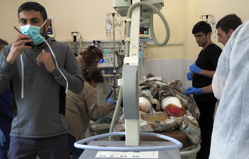 Doctors prepare a wounded person for surgery in a basement of a hospital during shelling by Azerbaijan's artillery in Stepanakert, the separatist region of Nagorno-Karabakh, Wednesday, Oct. 28, 2020. Nagorno-Karabakh officials said Azerbaijani forces hit Stepanakert, the region's capital, and the nearby town of Shushi with the Smerch long-range multiple rocket systems, killing one civilian and wounding two more. (AP Photo)