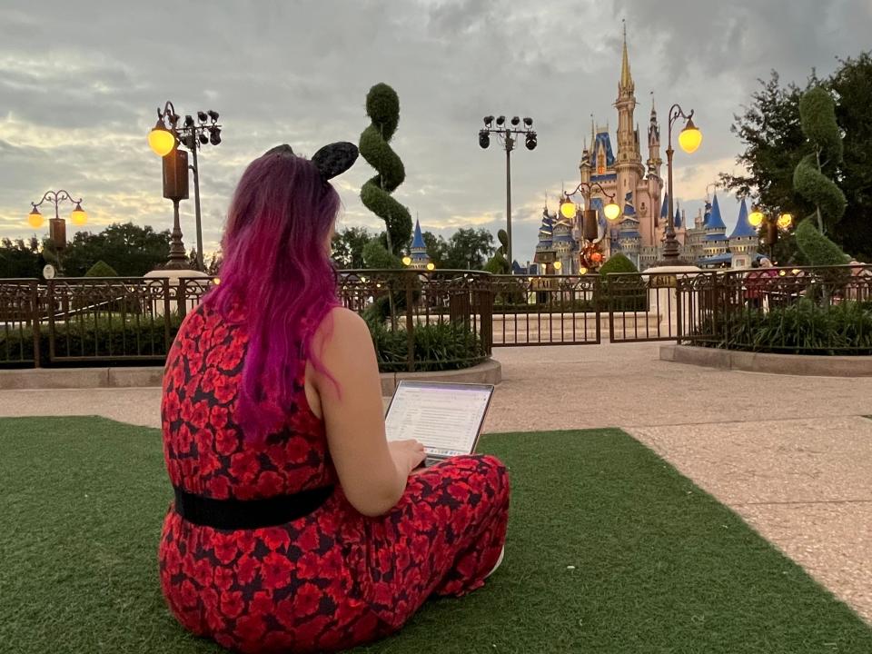 jenna clark working on grass in front of magic kingdom