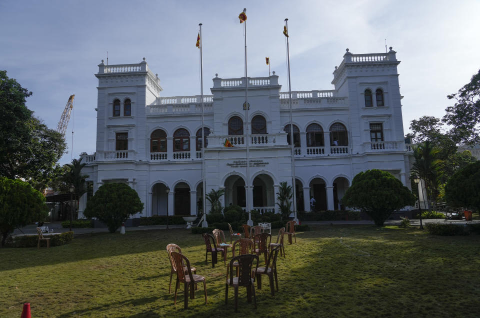 Empty chairs are seen on the lawn of prime minister Ranil Wickremesinghe's office building in Colombo, Sri Lanka, Thursday, July 14, 2022. Sri Lankan protesters retreated from government buildings they seized and military troops reinforced security at the Parliament on Thursday, establishing a tenuous calm in a country in both economic meltdown and political limbo.(AP Photo/Rafiq Maqbool)