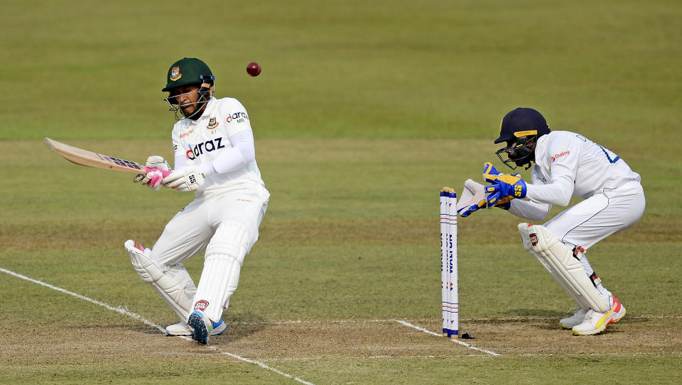 Bangladeshi batsman Mushfiqur Rahim plays a shot as Sri Lankan wicketkeeper Niroshan Dickwella watches during the second day of their first test cricket match in Pallekele, Sri Lanka, Thursday, April 22, 2021.( AP Photo/Sameera Peiris)