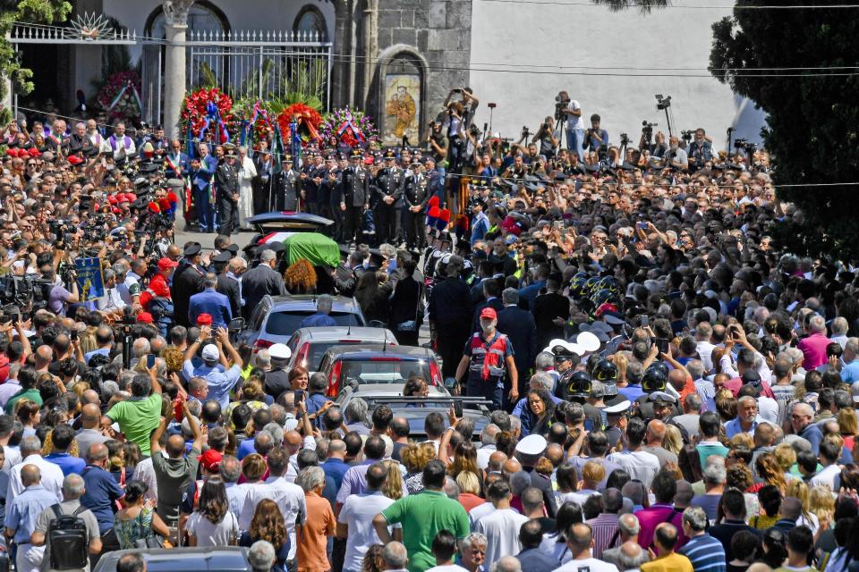 The coffin containing the body of the Carabinieri's officer Mario Cerciello Rega is carried during his funeral in his hometown of Somma Vesuviana, near Naples, southern Italy, Monday, July 29, 2019. Two American teenagers were jailed in Rome on Saturday as authorities investigate their alleged roles in the fatal stabbing of the Italian police officer on a street near their hotel. (Ciro Fusco/ANSA via AP)