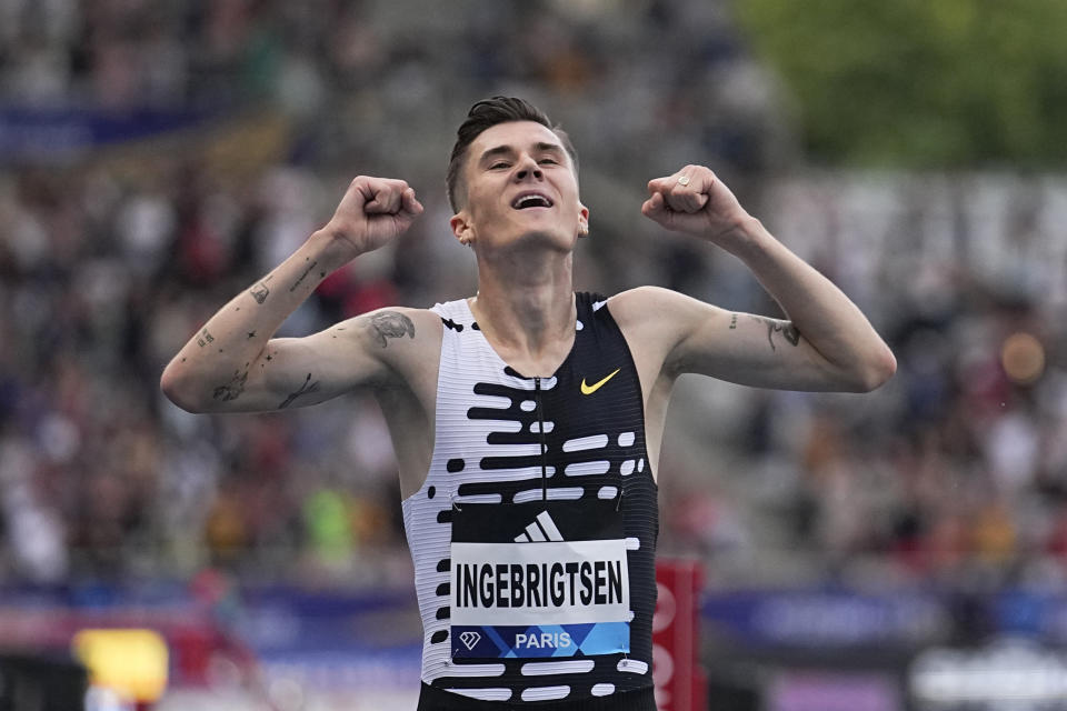 Jakob Ingebrigtsen of Norway crosses the finish line to win the men's 2-mile race setting a new world record at the Meeting de Paris Diamond League athletics meeting in Paris, Friday, June 9, 2023. (AP Photo/Michel Euler)