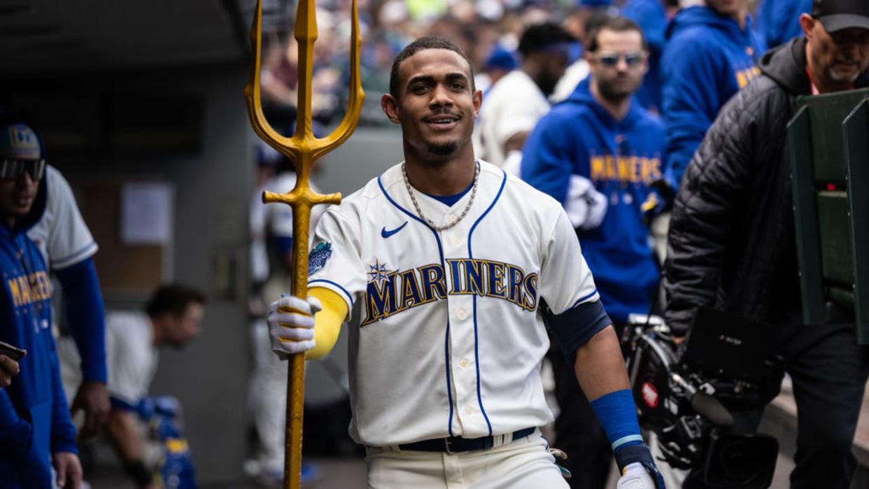 <div>Julio Rodriguez #44 of the Seattle Mariners poses with a trident in the dugout after hitting a solo home run against the Houston Astros during the second inning at T-Mobile Park on May 7, 2023 in Seattle, Washington.</div> <strong>(Photo by Stephen Brashear/Getty Images)</strong>
