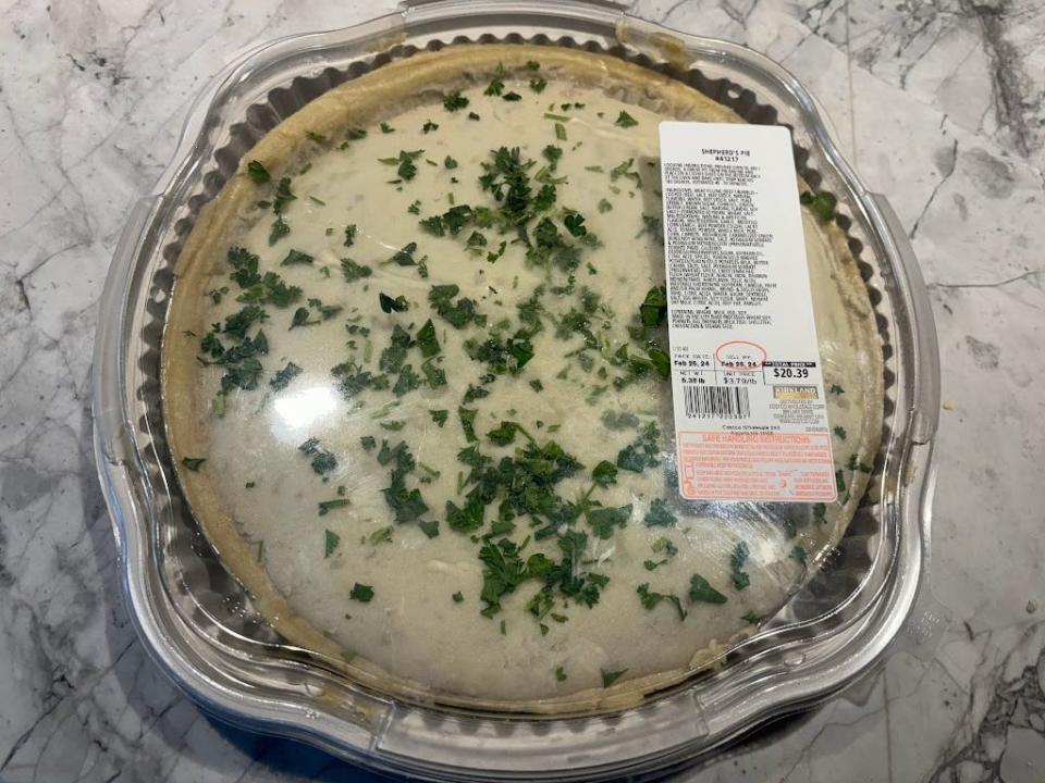 Shepherd's pie in a plastic container, with mashed potatoes and parsley on top