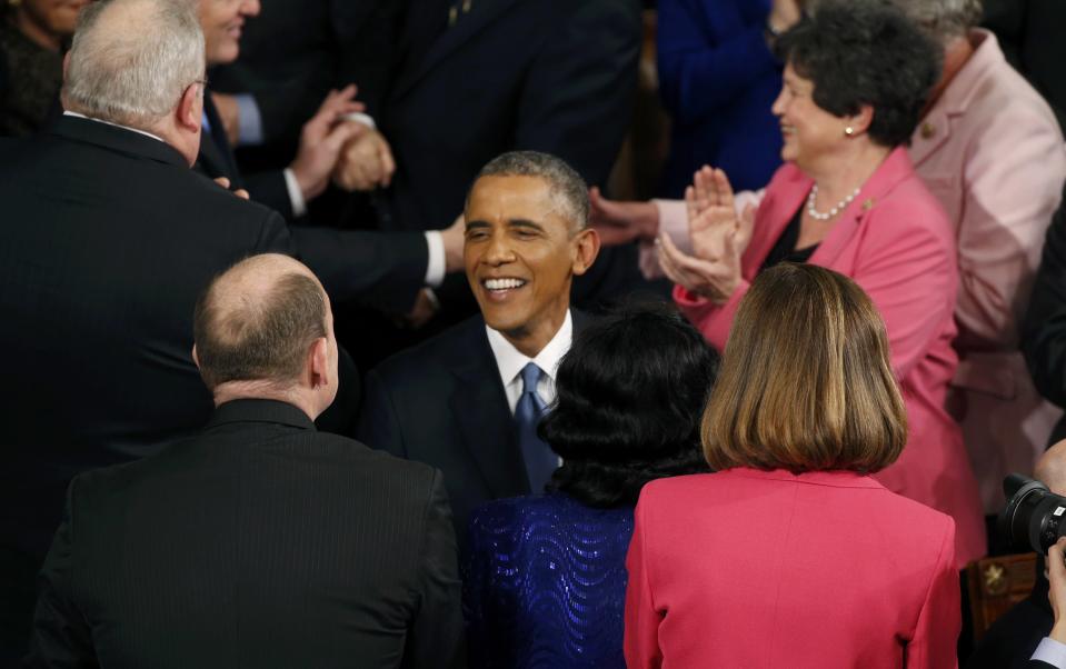 U.S. President Barack Obama is greeted as he arrives to deliver his State of the Union address to a joint session of the U.S. Congress on Capitol Hill in Washington