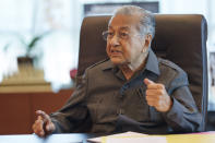 Malaysia's former Prime Minister Mahathir Mohamad speaks during an interview with The Associated Press at his office in Kuala Lumpur, Malaysia, Friday, Aug. 19, 2022. Mahathir expects Malaysia’s graft-tainted ruling party will hold general elections in coming months, and could win big, but the nonagenarian reformer vowed Friday that he would fight "even a losing battle" on principle. (AP Photo/Vincent Thian)