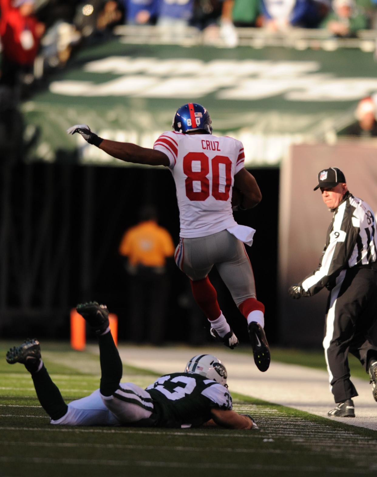 87804 Bergen; East Rutherford 12/24/2011 New York Giants wide receiver Victor Cruz (80) en route to his 99 yard touchdown run as New York Jets safety Eric Smith (33) chases Saturday at MetLife Stadium. TYSON TRISH/STAFF PHOTOGRAPHER