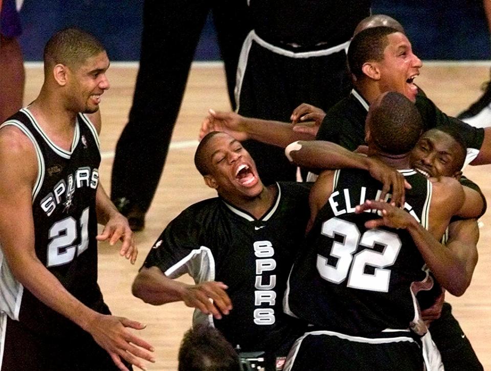 FILE - NBA Champions San Antonio Spurs, from left, Tim Duncan, Antonio Daniels, Gerard King, Sean Elliott, and Avery Johnson celebrate after defeating the New York Knicks 78-77 in Game 5 of the 1999 NBA Finals, June 25, 1999, at New York's Madison Square Garden. (AP Photo/Mark Lennihan, File)