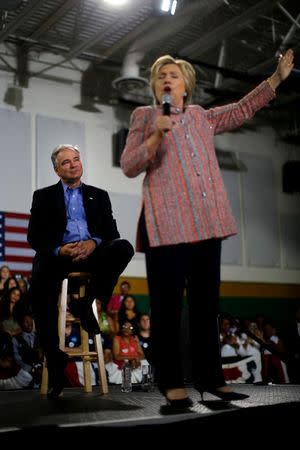 U.S. Senator Tim Kaine (D-VA) listens as Democratic U.S. presidential candidate Hillary Clinton speaks during a campaign rally at Ernst Community Cultural Center in Annandale, Virginia, U.S., July 14, 2016. REUTERS/Carlos Barria