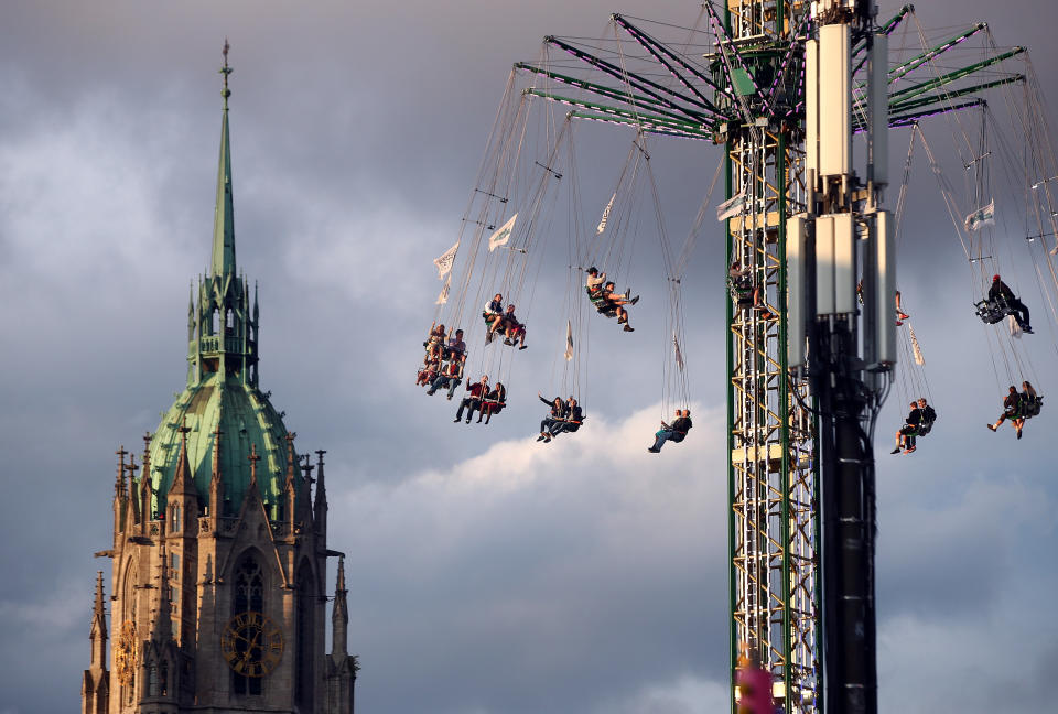 <p>Visitors ride a swing ride during the opening day of the 184th Oktoberfest. (Reuters/Michael Dalder) </p>