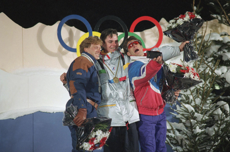 <p>Third-placed Lane Spina, right, takes a picture of winner Fabrice Becker of France, center, and second-placed Norway’s Rune Kristiansen after they received awards for a demonstration of men’s freestyle ballet skiing at the ’92 Winter Olympics in Tignes, France. (AP) </p>
