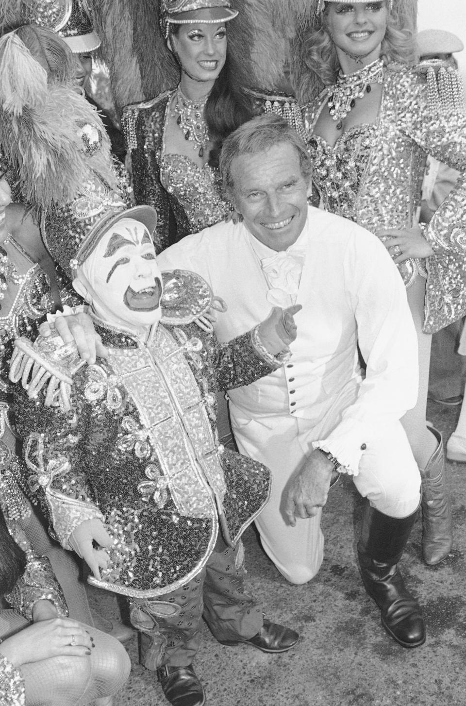 FILE - In this July 19, 1978 file photo, actor Charlton Heston is shown with Ringling Bros. and Barnum and Bailey Circus clown Prince Paul during the City of Hope's Celebrity Circus opening in Inglewood, Calif. The Ringling Bros. and Barnum & Bailey Circus will end "The Greatest Show on Earth" in May 2017, following a 146-year run of performances. Kenneth Feld, the chairman and CEO of Feld Entertainment, which owns the circus, told The Associated Press when the company removed the elephants from the shows in May of 2016, ticket sales declined more dramatically than expected. (AP Photo/Mclendon, File)