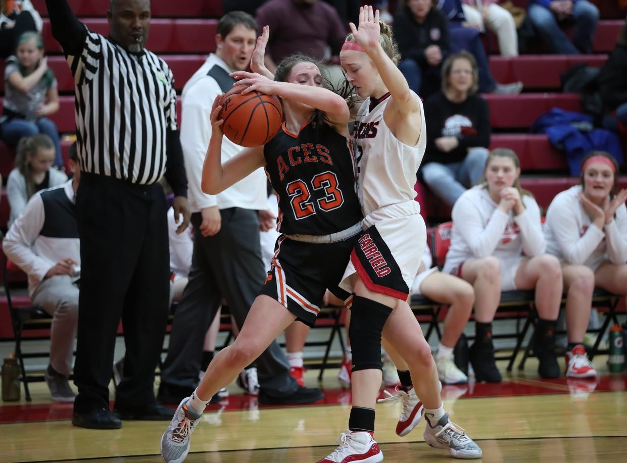 Amanda-Clearcreek freshman Taylor Evans attempts to keep the ball away from Fairfield Union defender Averey Cottrill during Saturday's Mid-State League-Buckeye Division game. The Falcons pulled out a 41-40 victory.