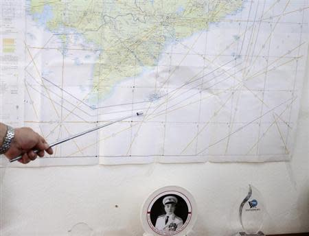 Air Force Deputy Chief of Staff Senior Colonel Do Duc Minh points to the map of a search area to find the missing Malaysia Airlines flight MH370, during a news briefing at a military airport in Ho Chi Minh city March 13, 2014. REUTERS/Kham