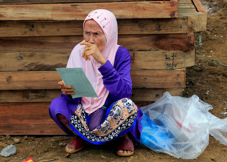 An evacuee with relief goods takes a break, after fleeing to an evacuation centre to avoid the fighting in Marawi between the government troops and Islamic State-linked militants, in Saguiaran town, Lanao Del Sur, southern Philippines September 10, 2017. REUTERS/Romeo Ranoco