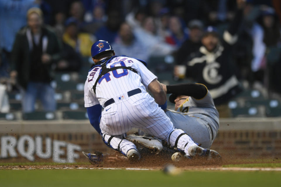 Chicago Cubs catcher Willson Contreras (40) tags out Pittsburgh Pirates' Daniel Vogelbach (19) at home plate during the fourth inning of a baseball game Tuesday, May 17, 2022, in Chicago. (AP Photo/Paul Beaty)