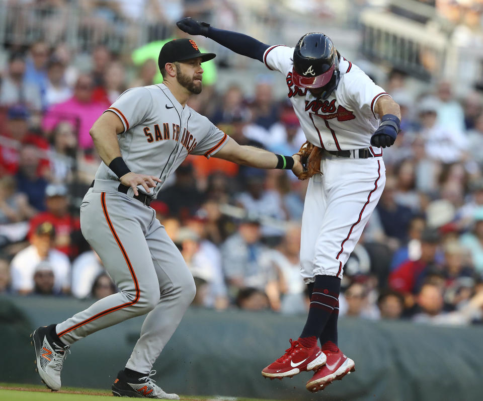 Atlanta Braves shortstop Dansby Swanson is tagged out on a run down by San Francisco Giants third baseman Evan Longoria on a fielders choice by Austin Riley during the first inning of a baseball game on Monday, June 20, 2022, in Atlanta. (Curtis Compton/Atlanta Journal-Constitution via AP)