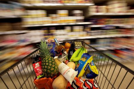 A shopping trolley is pushed around a supermarket in London, Britain, May 19, 2015. REUTERS/Stefan Wermuth/File Photo