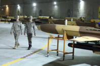 In this photo released on Saturday, May 28, 2022 by website of the Iranian Army, Chief of the General Staff of the Armed Forces Gen. Mohammad Hossein Bagheri, left, and Commander of the Army Gen. Abdolrahim Mousavi visit an underground drone base tunnel of the Army in the heart of the country's western Zagros Mountains. Iranian state television's report said Saturday, May 29, the tunnel was some 100 meters (330 feet) underground and was home to the Kaman-22 and Fotros drones, both capable of carrying cruise missiles. (Iranian Army via AP)