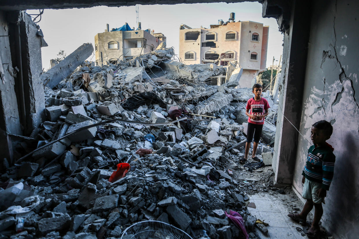 KHAN YUNIS, GAZA - NOVEMBER 6: Children stand in a building, destroyed during Israeli air raids in the southern Gaza Strip on November 6, 2023 in Khan Yunis, Gaza. The Israeli army has expanded its military assault. The Gaza strip, a besieged Palestinian territory, is under heavy bombing from Israel in response to the large-scale attack carried out on October 7 by Hamas in Israel. The international community is stepping up pressure for a humanitarian truce. (Photo by Ahmad Hasaballah/Getty Images)