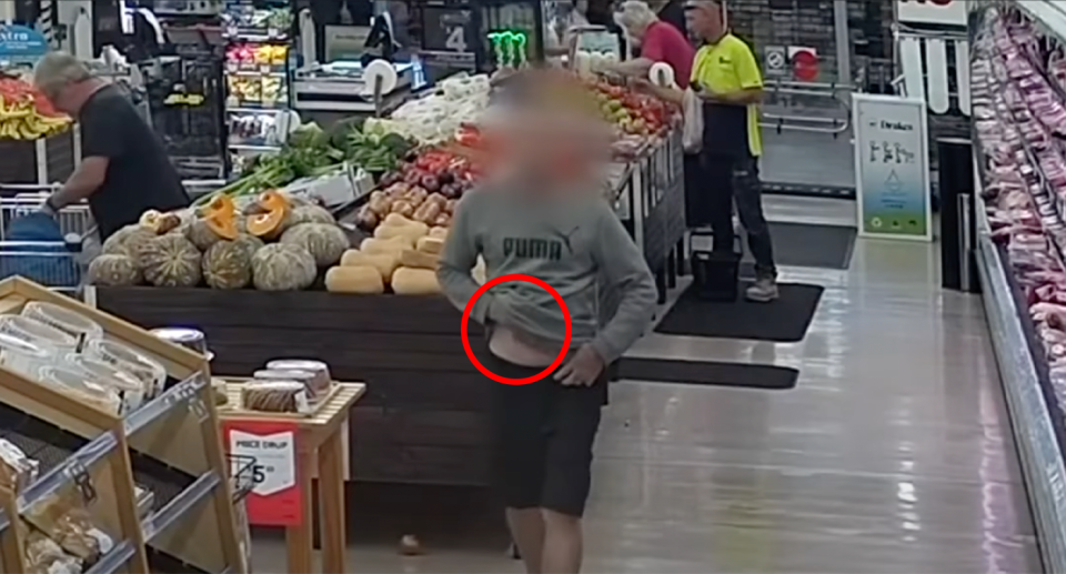 A man in seen in a supermarket stuffing a product under his shirt in bid to shoplift, 