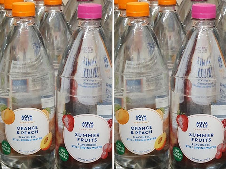 Bottles of flavored sparkling water with orange and pink caps at Aldi