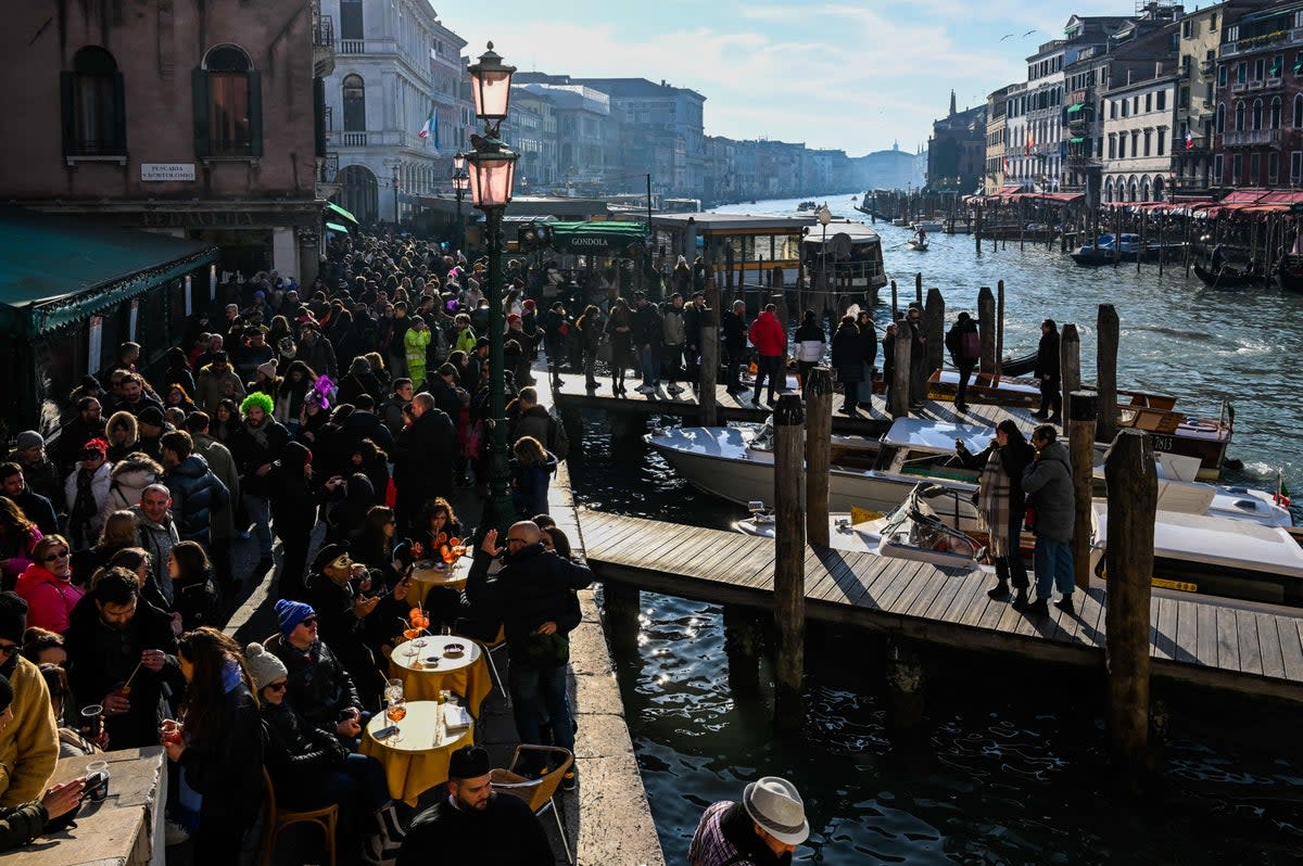 Tourists gather by the Grand Canal in Venice, Italy (AFP via Getty Images)