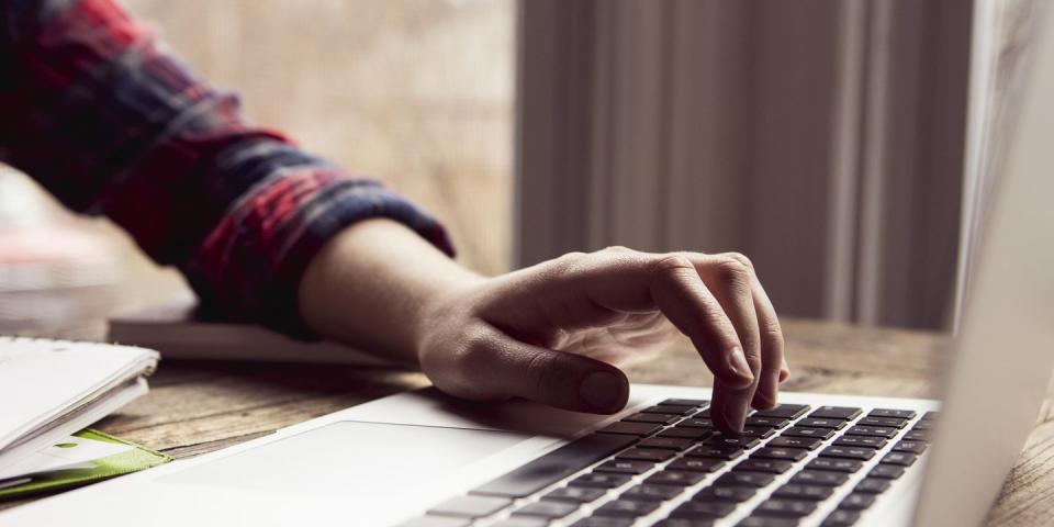 close up hand using laptop computer
