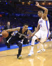 Memphis Grizzlies guard Courtney Lee (5) drives to the basket around Oklahoma City Thunder guard Thabo Sefolosha (25) during the first quarter of Game 1 of the opening-round NBA basketball playoff series in Oklahoma City on Saturday, April 19, 2014. (AP Photo/Alonzo Adams)