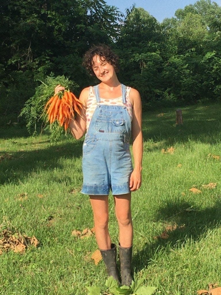 Maggie June Gates with carrots she grew and harvested in Monroe County in the summer of 2022.