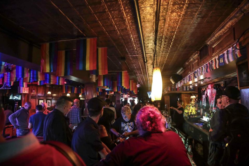 FILE - In this Monday, June 3, 2019, file photo, customers gather at the Stonewall Inn in New York. The Stonewall Inn’s owners say they won’t serve certain beers at the famous LGBT bar during Pride weekend to protest manufacturer Anheuser-Busch’s political contributions to some politicians who have supported anti-LGBT legislation. (AP Photo/Bebeto Matthews, File)