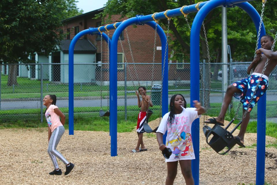 Syracuse, NY. Children play and pose for the camera at playground close to I-81 in Pioneer Homes. July 16, 2021.