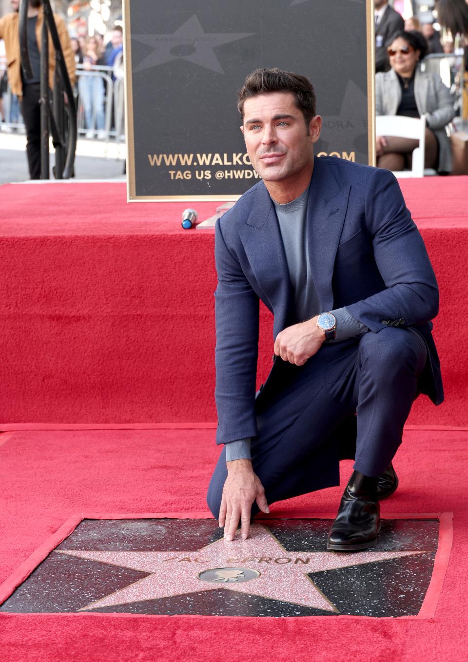 Zac Efron poses with his star during his Hollywood Walk of Fame star ceremony on Dec. 11, 2023, in Hollywood, California.