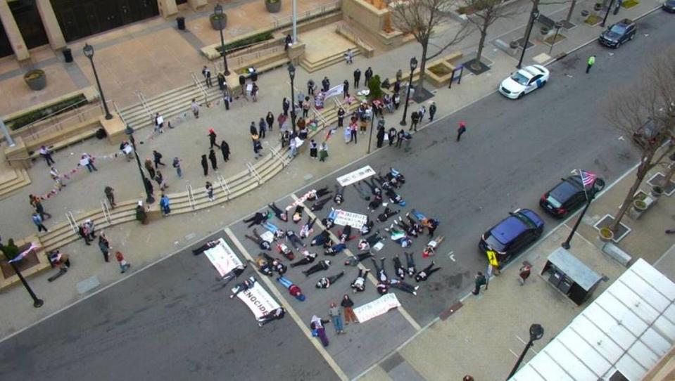 Demonstrators seeking a cease fire in the Israel-Hamas war stage a die-in downtown Raleigh Thursday afternoon.