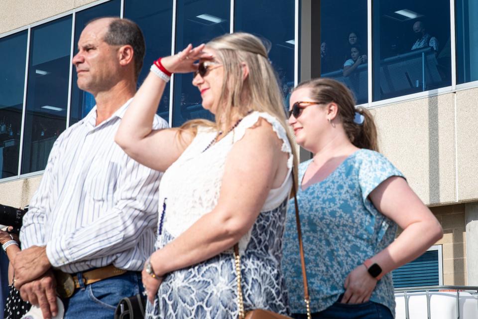 Family members of U.S. Army Air Force Sgt. Herald Ray Boyd, who died in Germany during World War II, wait for the fallen soldier's remains to arrive at Corpus Christi International Airport on Friday, Sept. 9, 2022, in Texas. People in the terminal watch through the window as a Southwest airplane carries the remains.
