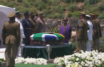 Military personnel stand beside the coffin of former South African President Nelson Mandela at his burial site in his ancestral village of Qunu in the Eastern Cape province, 900 km (559 miles) south of Johannesburg, in this still image taken from December 15, 2013 video courtesy of the South Africa Broadcasting Corporation (SABC). REUTERS/SABC via Reuters TV (SOUTH AFRICA - Tags: POLITICS OBITUARY) ATTENTION EDITORS - FOR EDITORIAL USE ONLY. NOT FOR SALE FOR MARKETING OR ADVERTISING CAMPAIGNS. NO SALES. NO ARCHIVES. SOUTH AFRICA OUT. NO COMMERCIAL OR EDITORIAL SALES IN SOUTH AFRICA. THIS PICTURE WAS PROCESSED BY REUTERS TO ENHANCE QUALITY