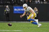 Los Angeles Chargers quarterback Justin Herbert (10) chases down his own fumble during the first half of an NFL football game against the Las Vegas Raiders, Sunday, Dec. 4, 2022, in Las Vegas. (AP Photo/David Becker)