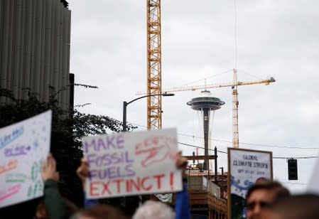 Google employees hold signs as they join Amazon employees walking out from their jobs during a Climate Strike near the Amazon Spheres in Seattle
