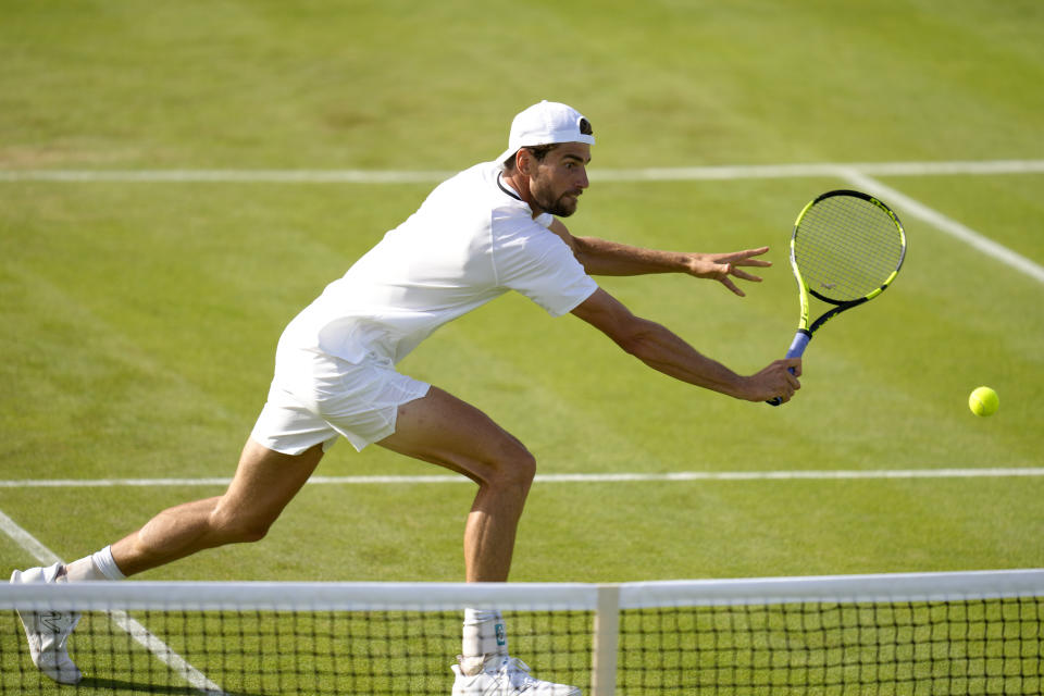 Maxime Cressy of the US serves to Canada's Felix Auger-Aliassime during their singles tennis match on day two of the Wimbledon tennis championships in London, Tuesday, June 28, 2022. (AP Photo/Kirsty Wigglesworth)