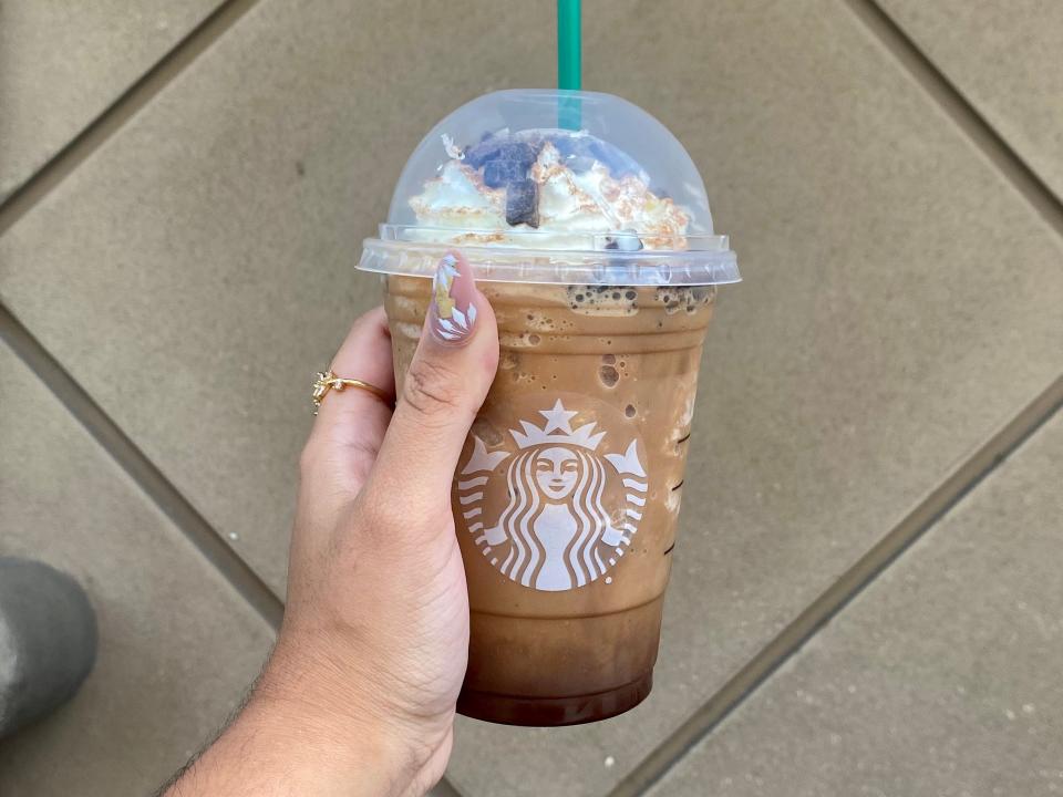 Melissa holding a Starbucks' Grande Jack Skellington Frappuccino.