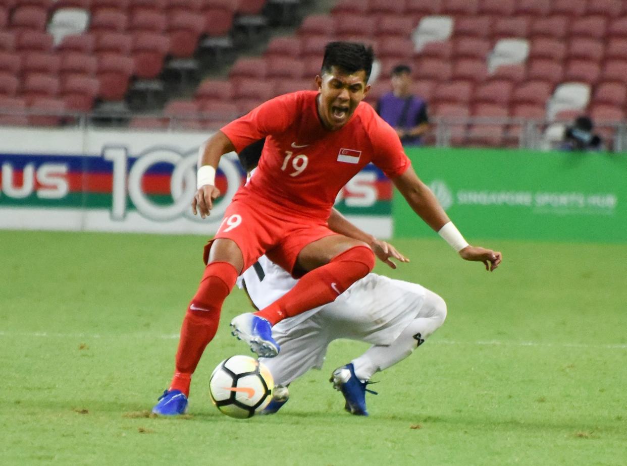 Singapore striker Khairul Amri is tackled from behind by a Myanmar defender during their international friendly at the National Stadium (PHOTO: Zainal Yahya/Yahoo News Singapore)